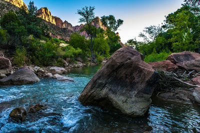 Scenic view of rocks in river against sky