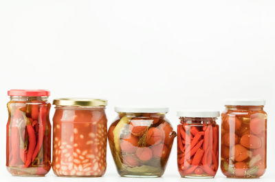 Close-up of glass jar against white background