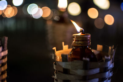 Close-up of illuminated candles against blurred background