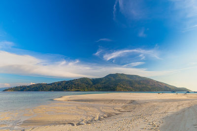 Scenic view of beach against blue sky