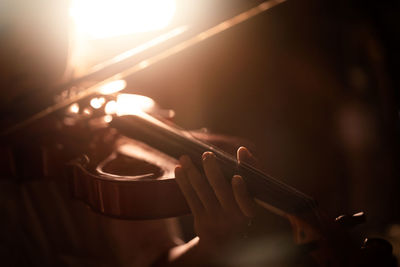 Close-up of hand holding guitar