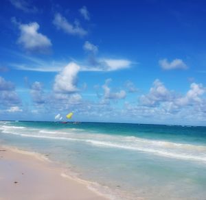 Scenic view of beach against blue sky