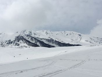 Scenic view of snow covered mountains against sky