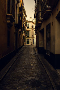 Narrow alley amidst buildings in city