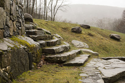 A beautiful stone wall and staircase on a foggy spring day
