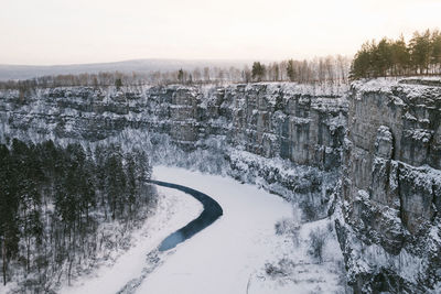 Snow covered landscape against clear sky