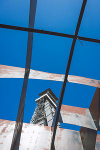 Low angle view of abandoned building against blue sky