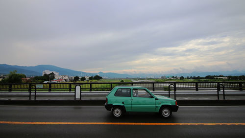 Cars on road against sky