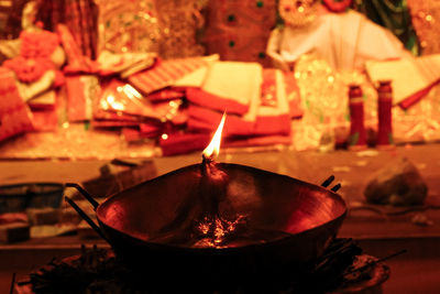 Close-up of lit tea light candles in temple