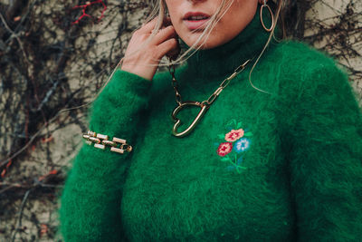 Close-up of young woman with arms raised