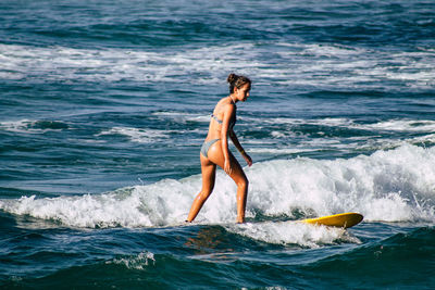 Side view of man surfing in sea