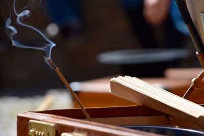 Close-up of incense stick against blurred background