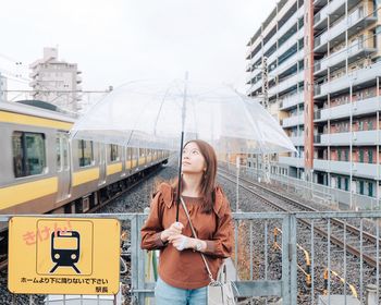 Woman with umbrella in city