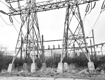 Low angle view of electricity pylon against sky