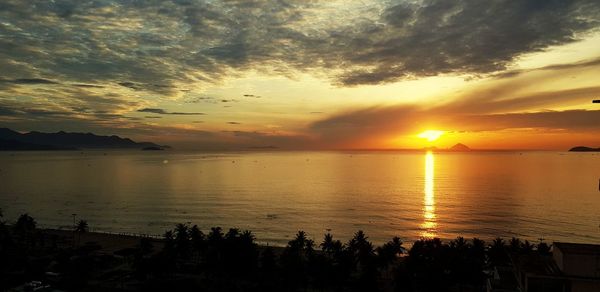 Scenic view of sea against romantic sky at sunset