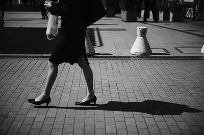 Low section of people standing on tiled floor