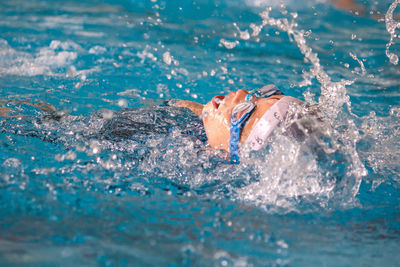 Boy swimming in pool