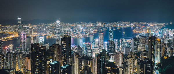 High angle view of illuminated city buildings at night