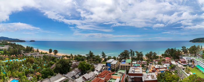 High angle view of townscape by sea against sky