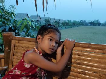 Portrait of girl sitting on seat