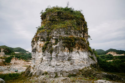 Low angle view of rock formation against sky