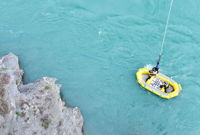 High angle view of person bungee jumping over river