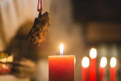 Close-up of burning candles in magical dark bar