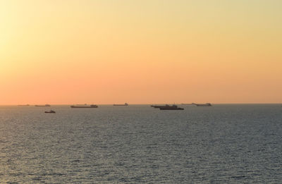 Scenic view of sea against clear sky during sunset