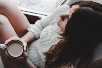 Midsection of woman holding coffee cup