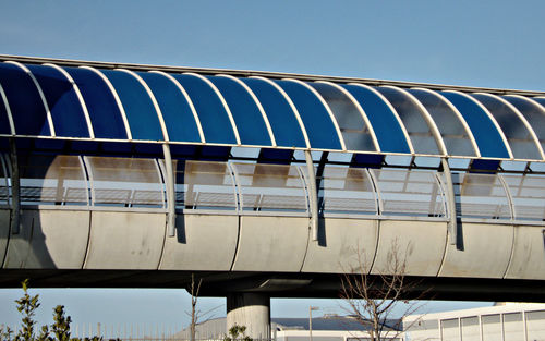 Low angle view of bridge against clear blue sky