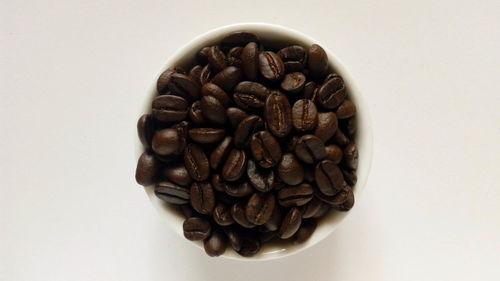 Directly above shot of coffee beans against white background