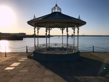 Pier on sea against sky during sunset