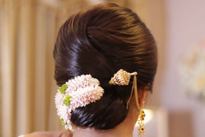 Close-up portrait of woman with pink flower