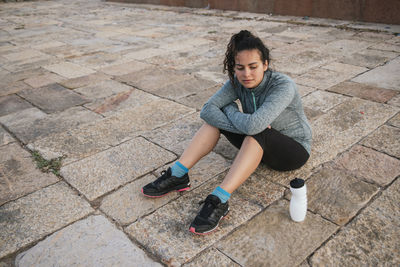 Tired girl resting with water