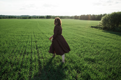 Rear view of woman on field