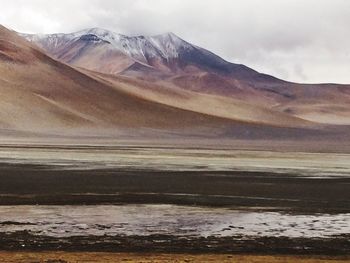 Scenic view of lake against cloudy sky