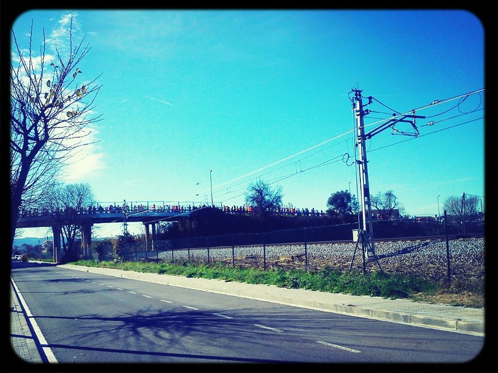 transfer print, clear sky, electricity pylon, auto post production filter, power line, transportation, tree, street light, electricity, power supply, road, connection, railroad track, sky, blue, power cable, copy space, cable, street, outdoors