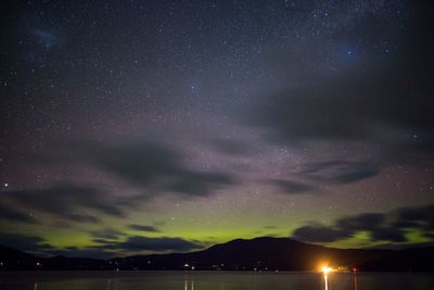 Scenic view of lake against star field at night