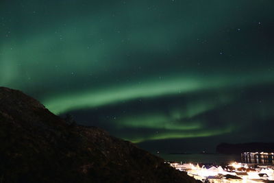 Panoramic view of illuminated city against sky at night