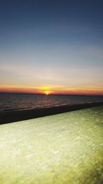 Scenic view of sea against clear sky during sunset