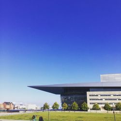 View of modern building against clear blue sky