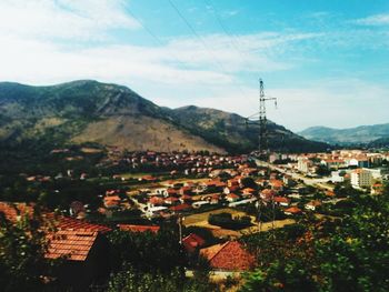 Houses in town against sky