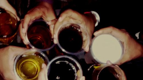 Close-up of hand holding beer glass