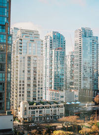 Modern buildings in city against sky