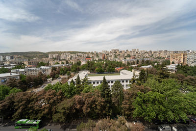 High angle view of trees and buildings against sky
