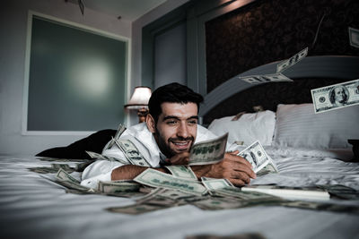 Portrait of man relaxing on bed at home