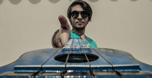 Portrait of young man holding guitar