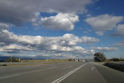 View of highway against cloudy sky