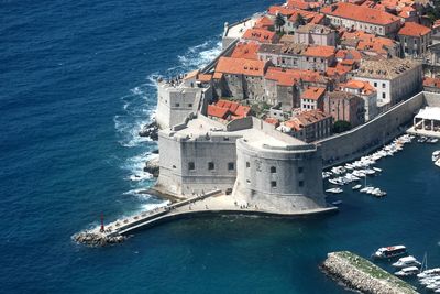 High angle view of sea by buildings in city