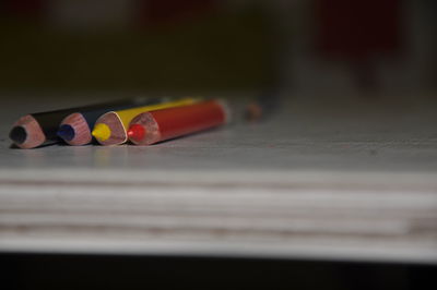 Close-up of multi colored pencils on table